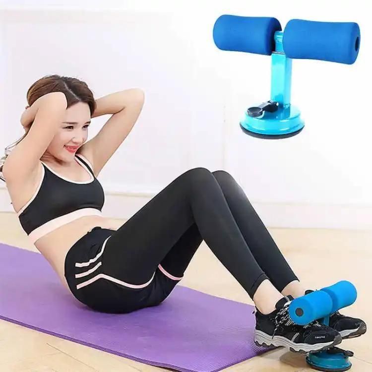 Woman using blue sit-up bar assistant on yoga mat for home workout, IndianChic fitness accessory