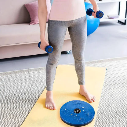 Woman exercising on yoga mat with blue tummy twister and dumbbells, IndianChic fitness